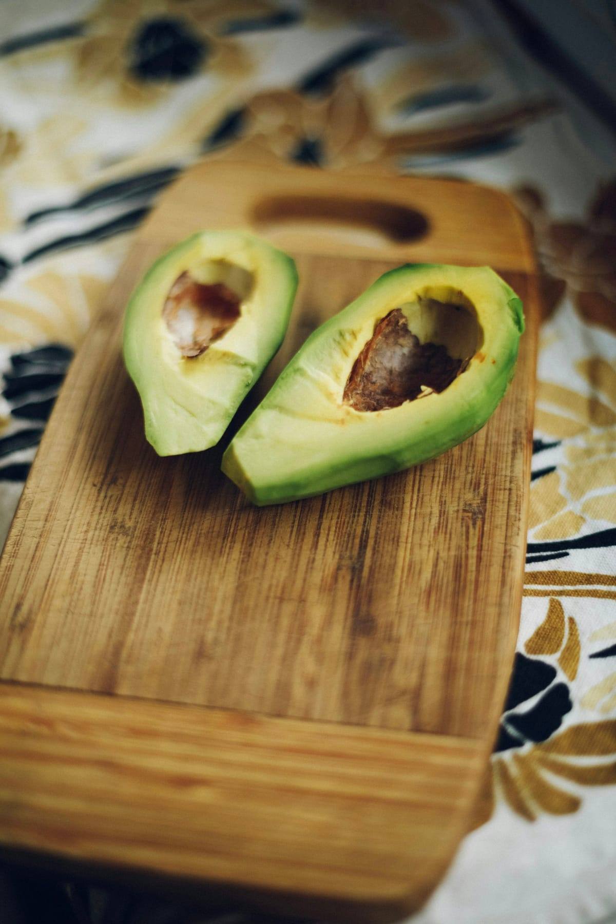 Halved avocado with pit