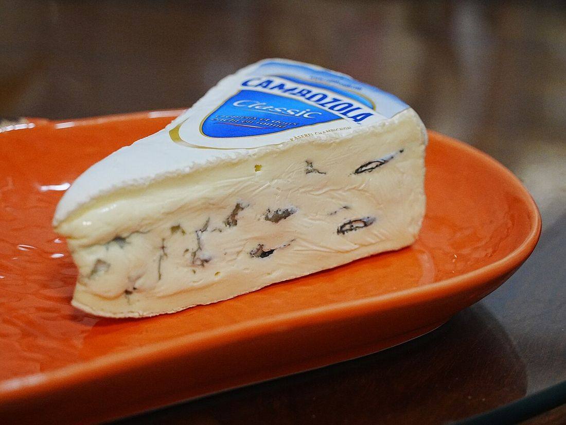 A Trangle shaped Cambozola on the pumpkin shaped plate