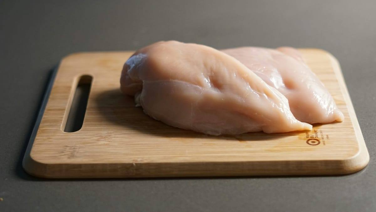 Raw chicken breast on parchment