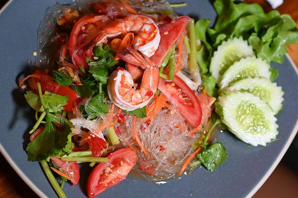 DFC 1491 Zesty Thai glass noodle salad topped with plump shrimp fresh tomatoes cucumber slices and...