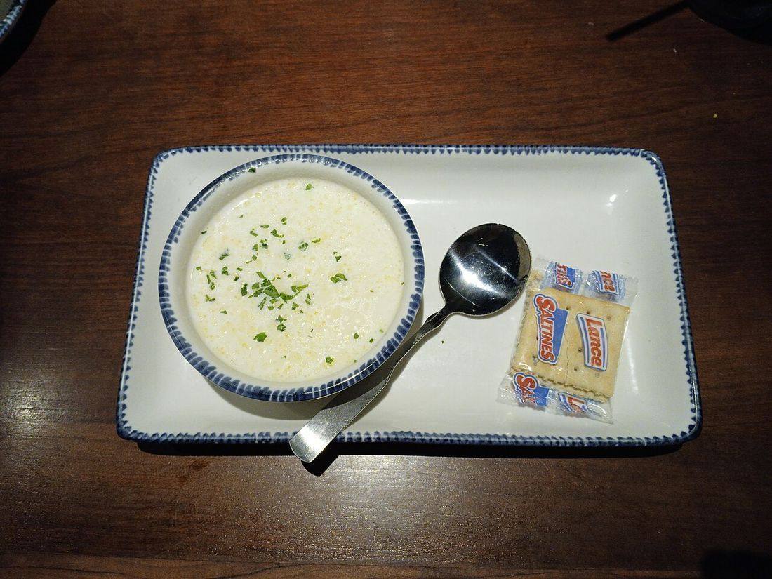 Cup of clam chowder, with saltines