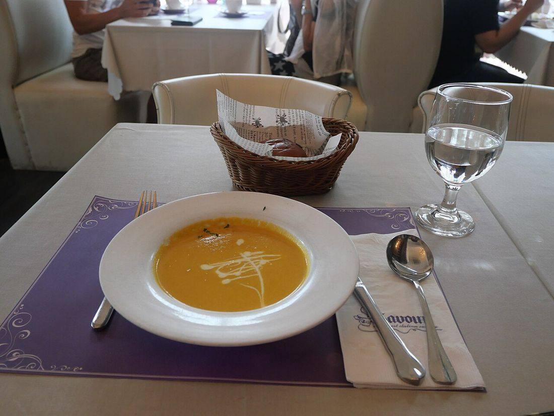 Carrot cream soup with bread in savour cafe (Cream Of Carrot Soup)