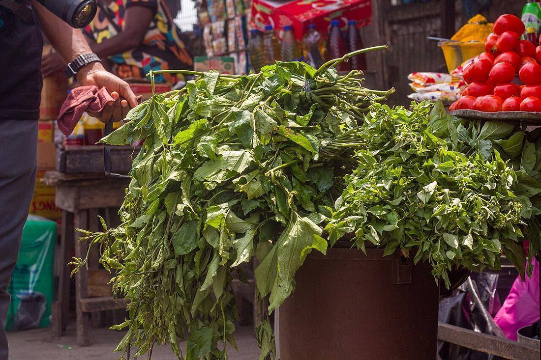 Fresh ugu leaves displayed at market stall (Fluted Pumpkin Leaves)