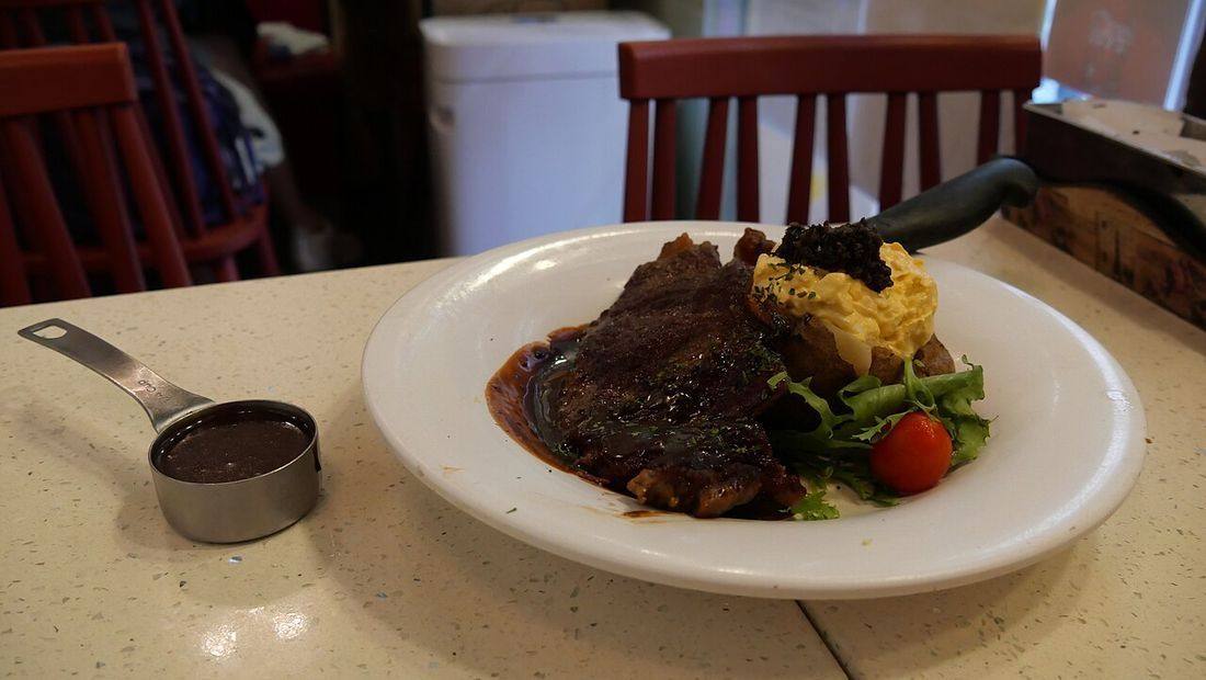 Beef steak with baked potato with egg sauce and truffle and black pepper sauce (Peppercorn Sauce)