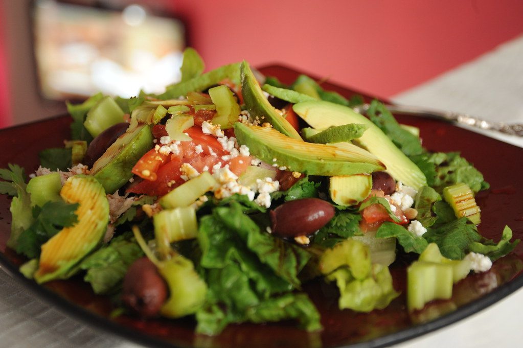 Perfectly delightful summer salad, avocado, celery, romaine lettuce, olives, feta cheese, almonds, tomato,...
