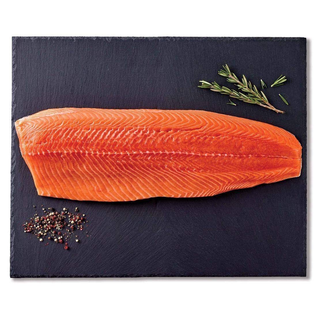 Raw salmon fillet on parchment