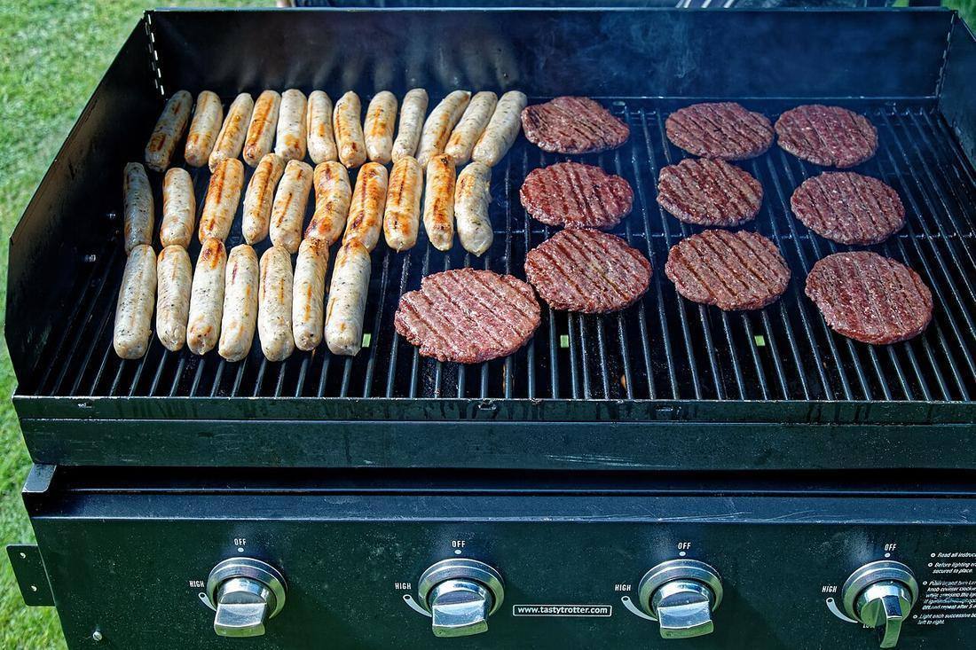 Grilled sausage hamburger Copped Hall house and gardens open day event, Essex, England (Summer Sausage)