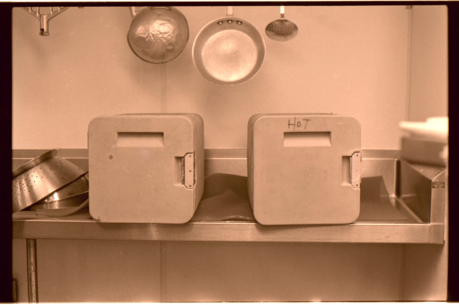 Stainless steel food containers stacked on a shelf