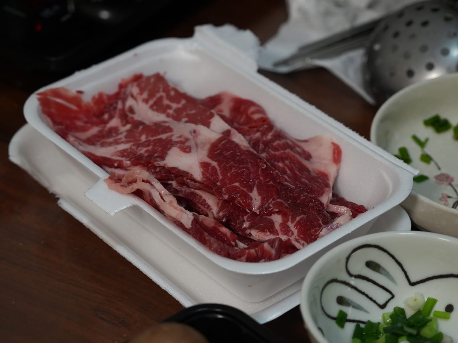 Fresh raw beef on a tray, ready to be portioned and frozen